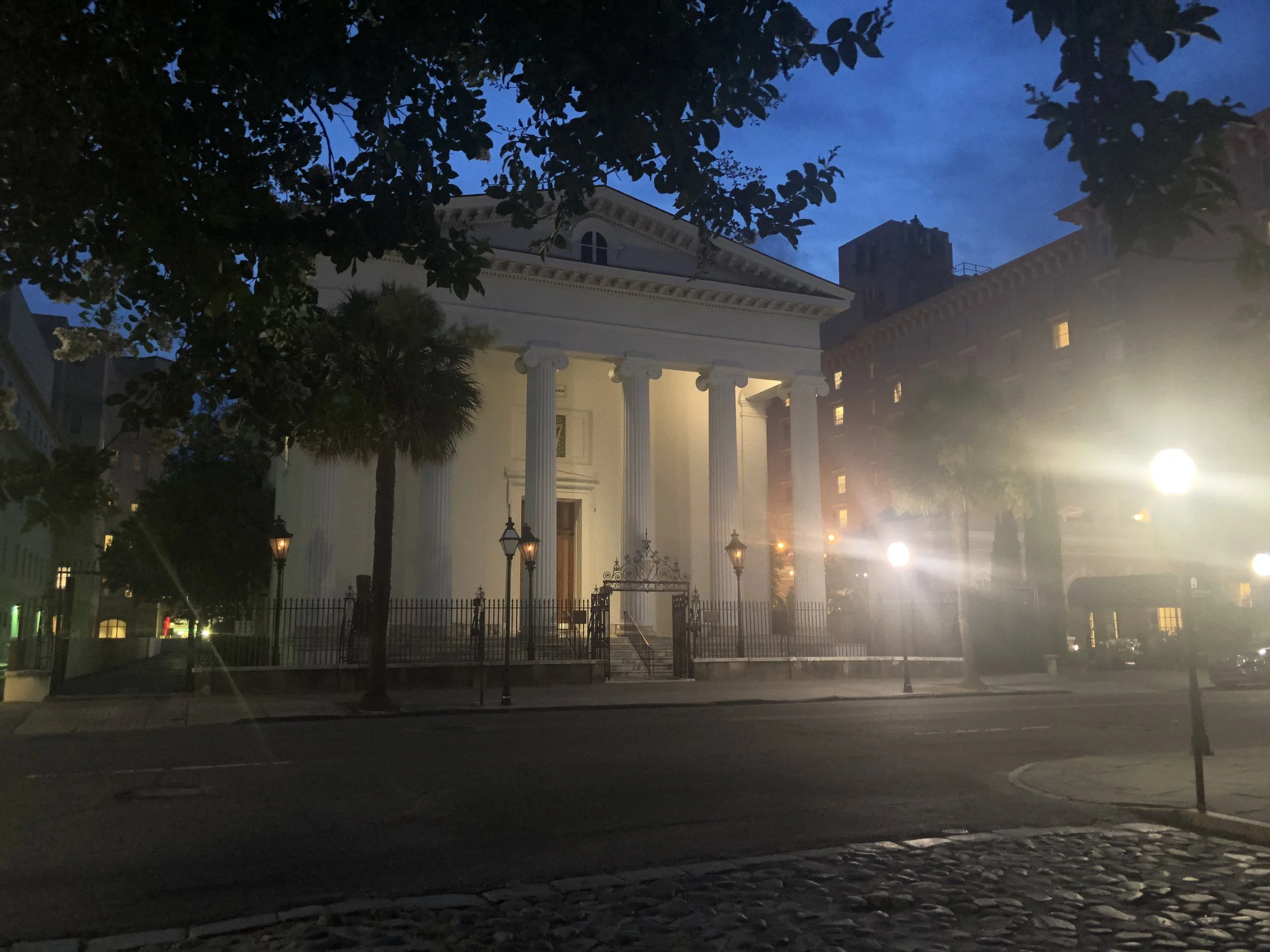 Evening Reverence: Bathed in soft evening light beneath a deepening twilight sky, this historic church stands as a quiet landmark in the heart of Savannah. The glowing columns and surrounding lanterns evoke the city's enduring elegance, where centuri