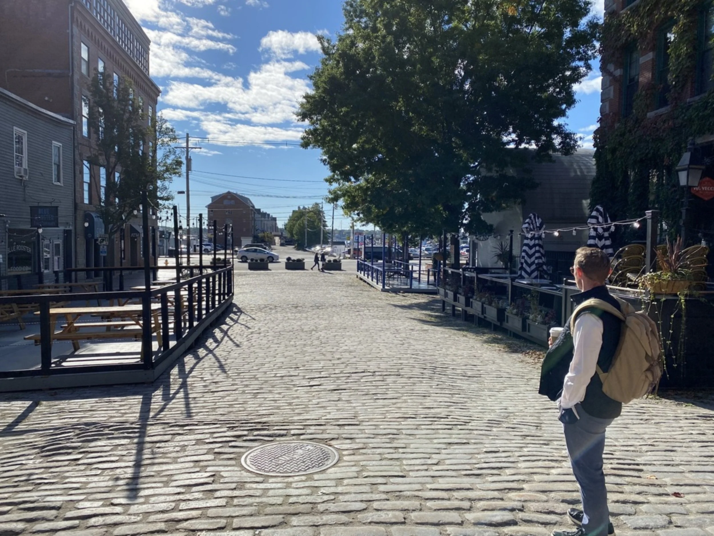 Harbor Street - Morning Light in Portland: Morning sunlight illuminates a cobblestone street leading toward Portland’s waterfront, revealing the quiet rhythm of a city beginning its day. Combining architectural character, coastal influence, and urban