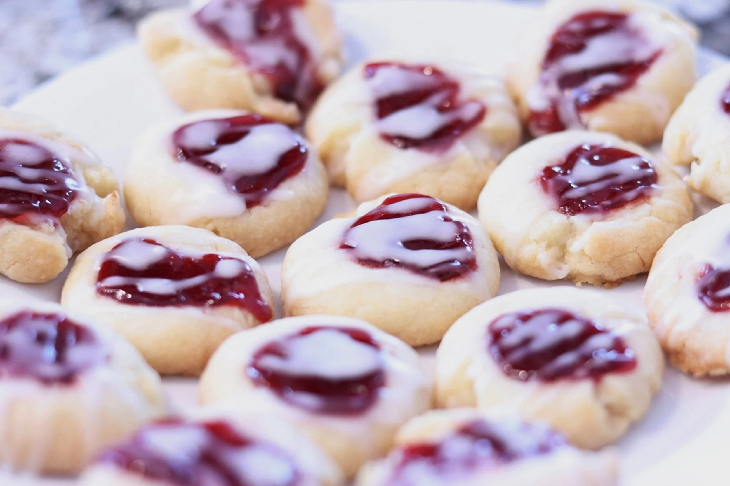 Raspberry Thumbprints: Delicate raspberry thumbprint cookies finished with a light glaze showcase the artistry and comfort of freshly prepared baked goods. The image brings warmth, sweetness, and a sense of welcoming hospitality to bakeries, cafés, b