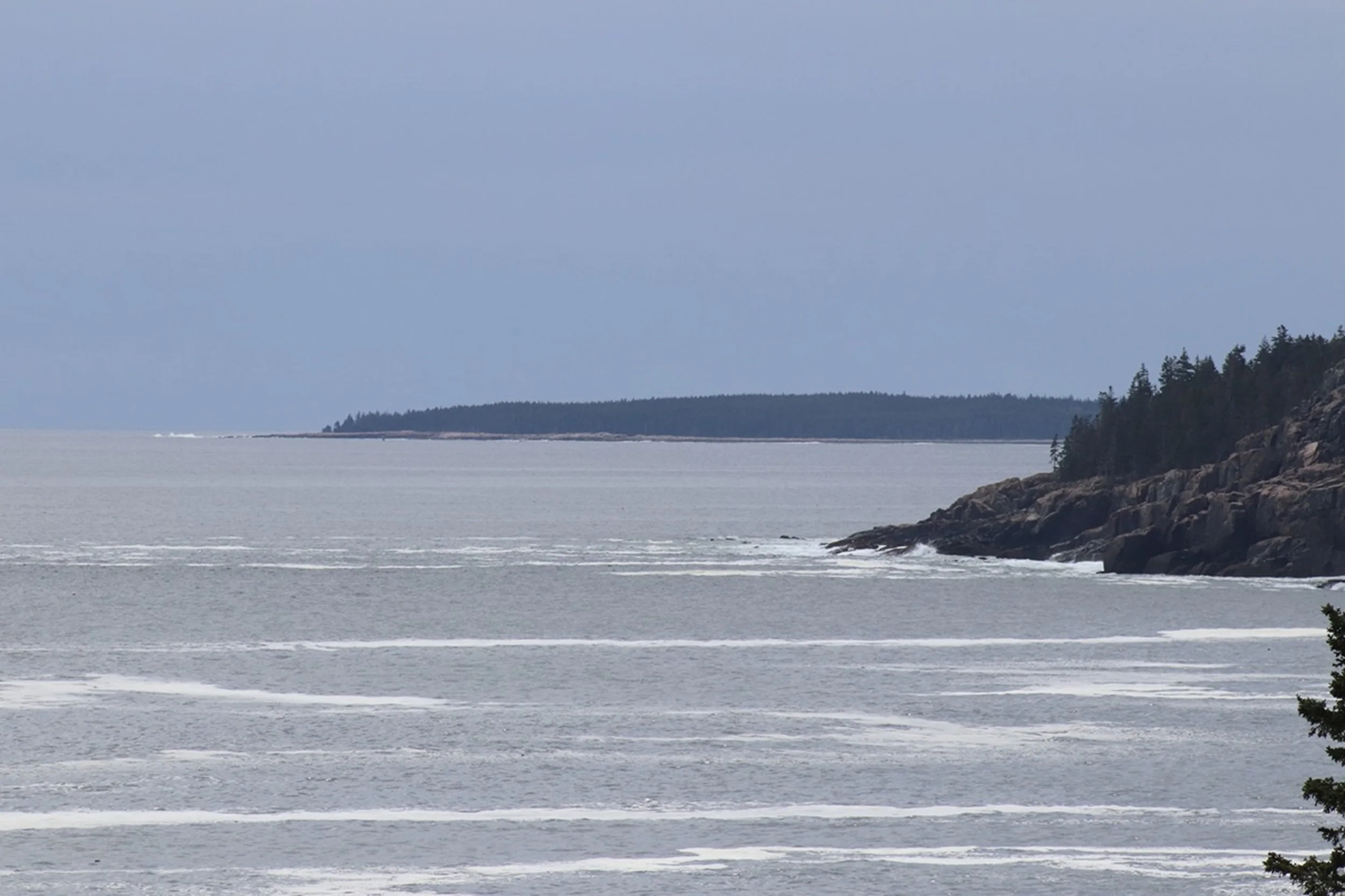Cliff Line and Quiet Tides - Bar Harbor Coast:  Soft coastal light settles across distant headlands and calm Atlantic waters, creating a composition defined by balance, scale, and serenity. This image brings a refined sense of coastal atmosphere to b