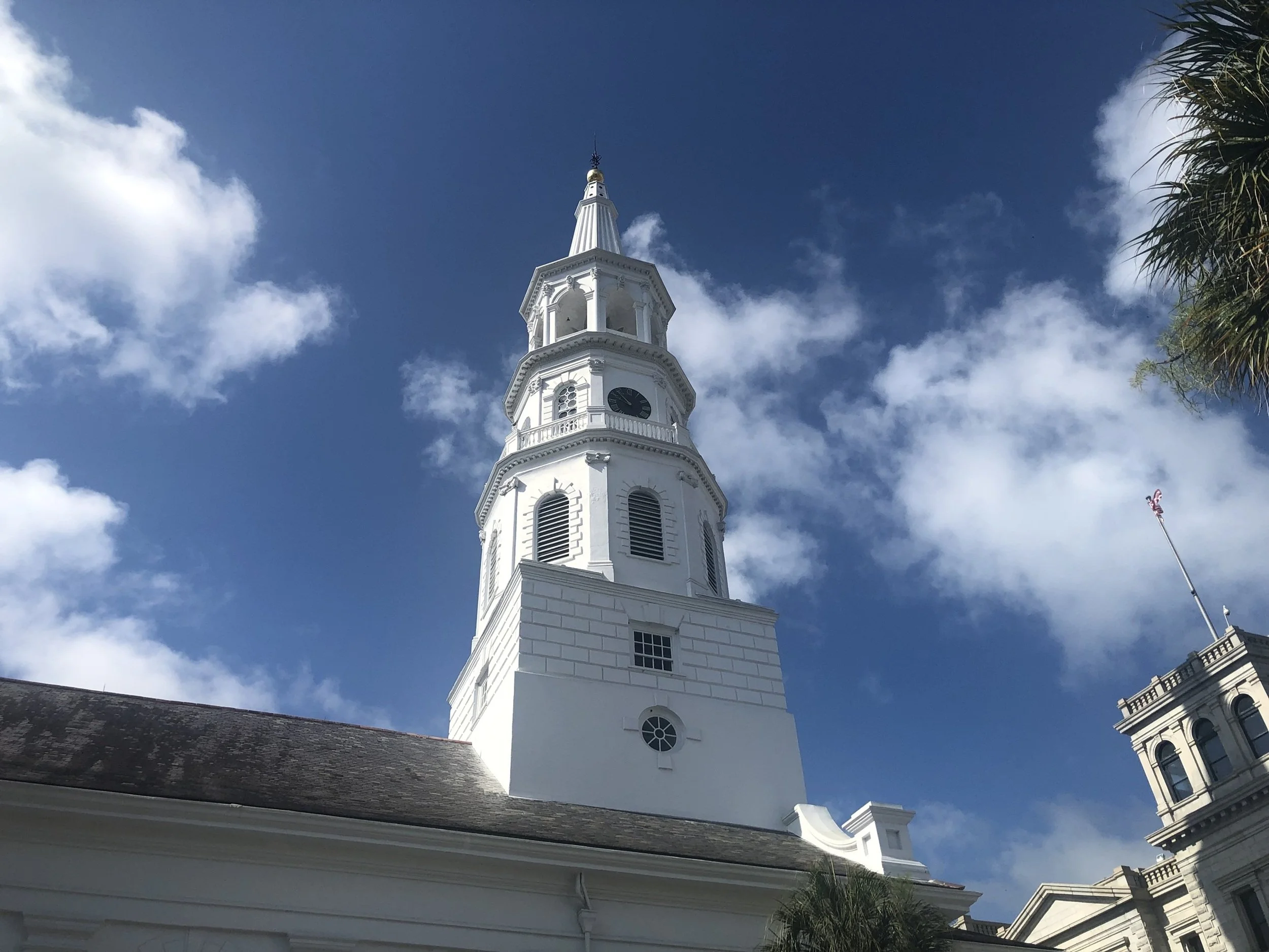 Steeple Against the Blue: A white church steeple rises into a brilliant Southern sky, highlighting the architectural grace and enduring heritage of Charleston. Clean lines, bright light, and historic significance make this image a refined choice for 