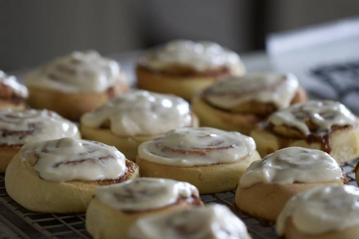 Morning Ritual - A tray of freshly iced cinnamon rolls captures the warmth, craftsmanship, and quiet anticipation of a memorable morning. Created for boutique hotels, cafés, bakeries, and hospitality interiors, this image celebrates the simple ritual
