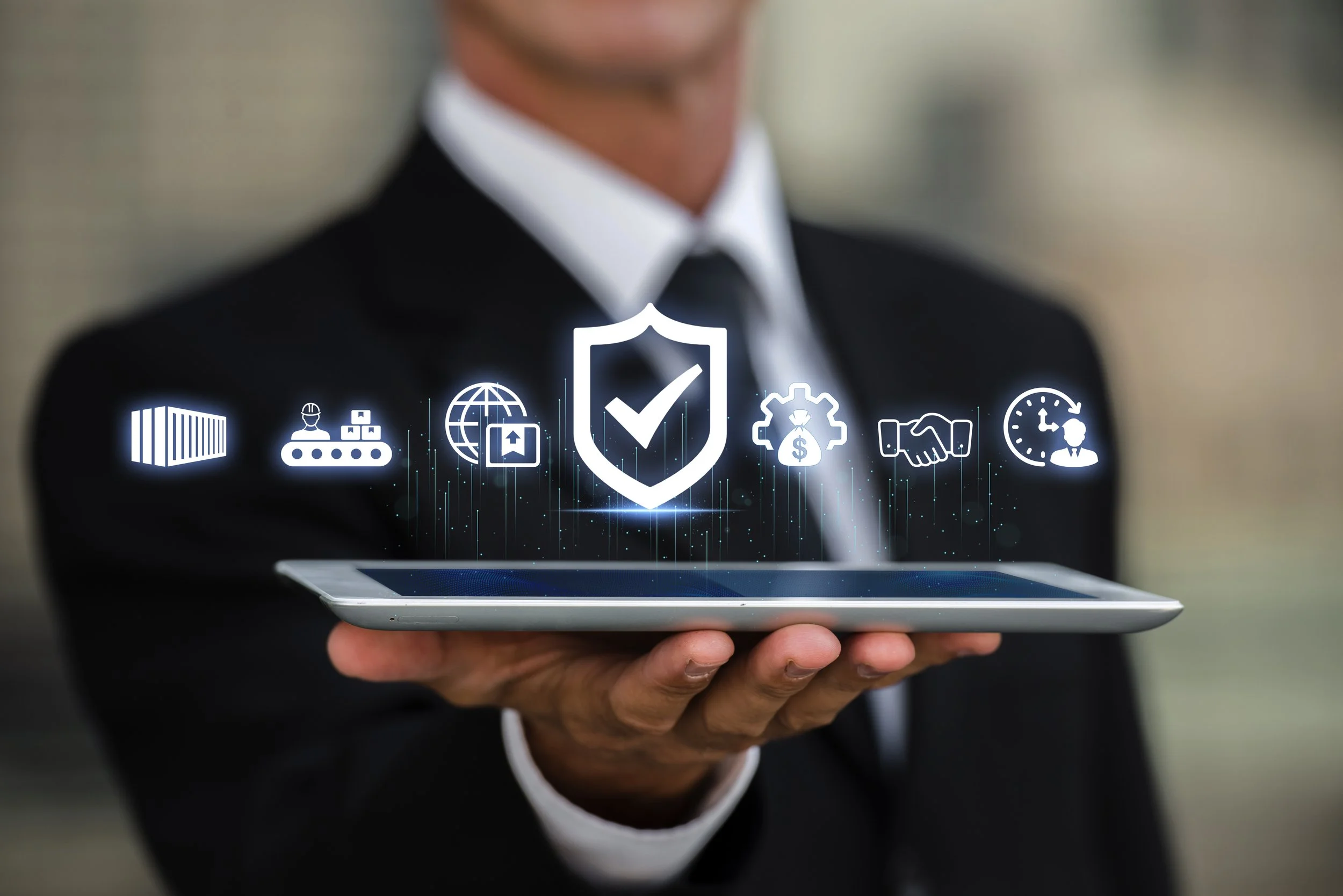 A person in a suit holding a tablet with digital icons floating above it, including a shield with a check mark, barcode, worker, globe, shipping box, clock, and handshake, symbolizing cybersecurity and digital security.