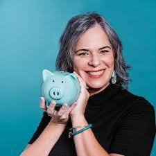 Woman holding a blue piggy bank smiling