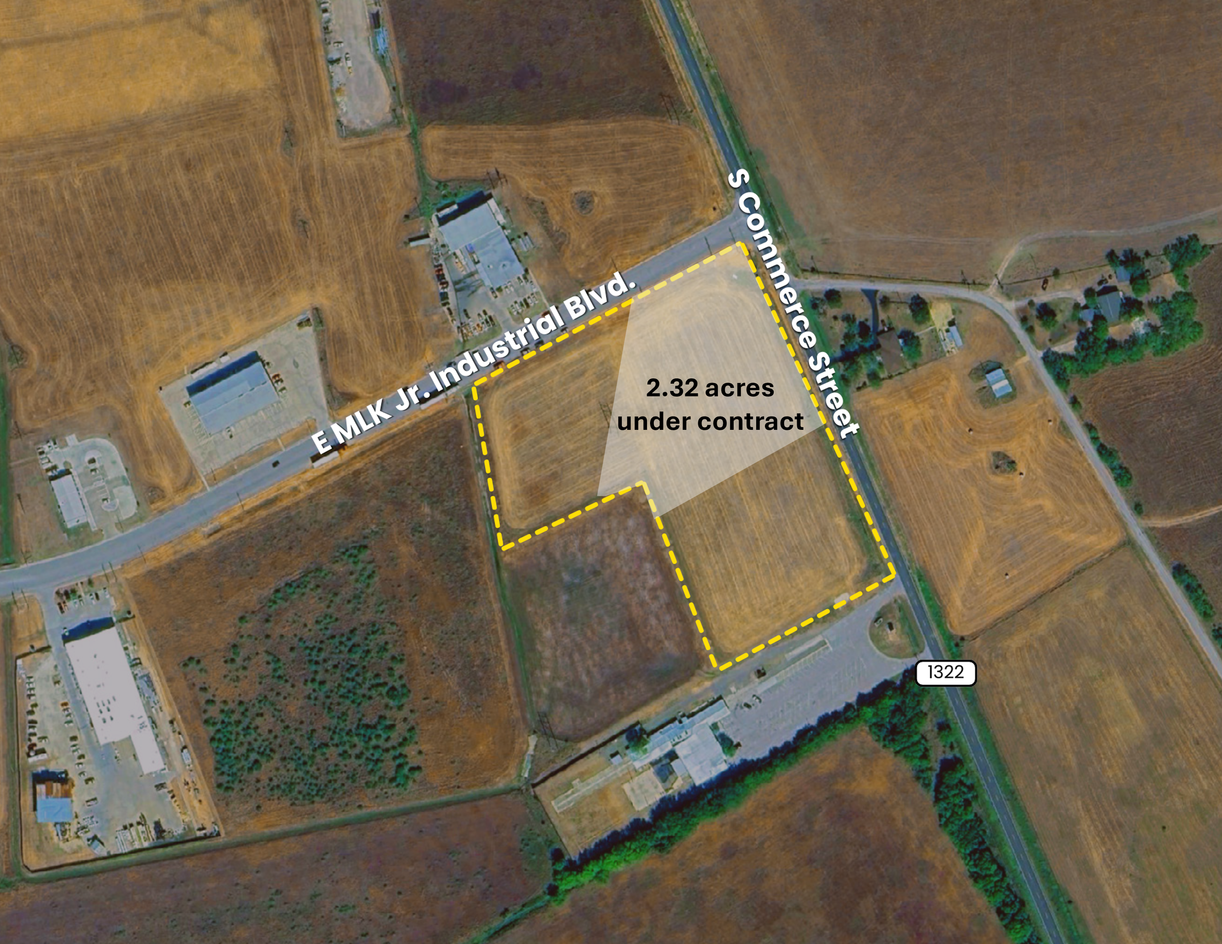 Satellite view of farmland and commercial buildings, with an outlined area marked as 2.32 acres under contract, near E MLK Jr. Blvd. and S. Commerace Street.