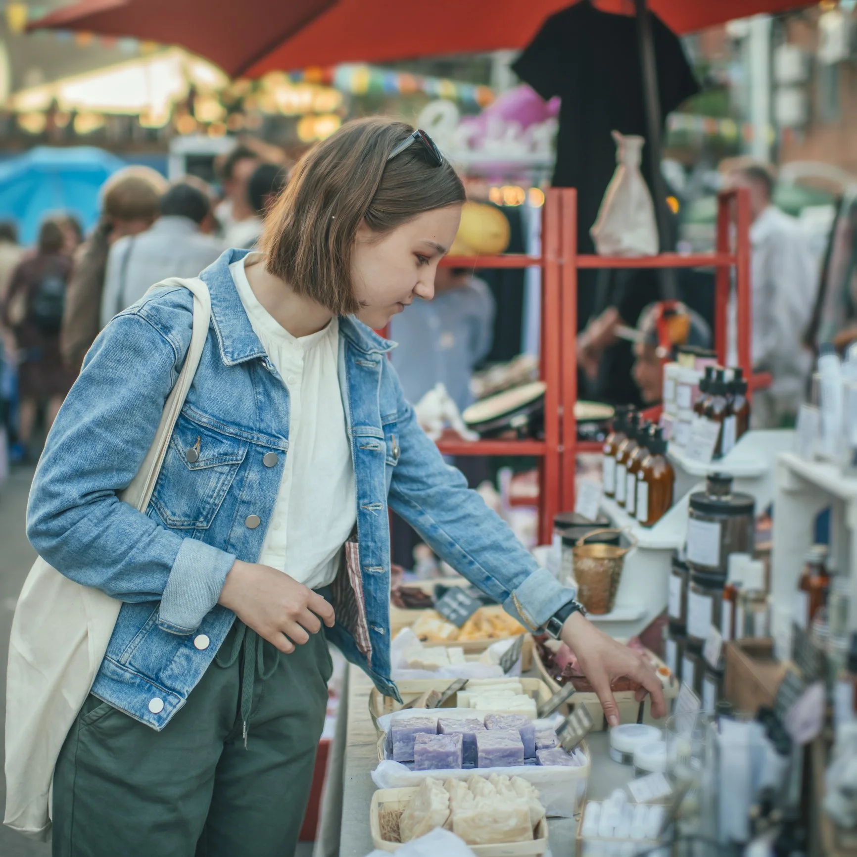 A young knoxville woman shopping at the playful pop up market vendor bootht
