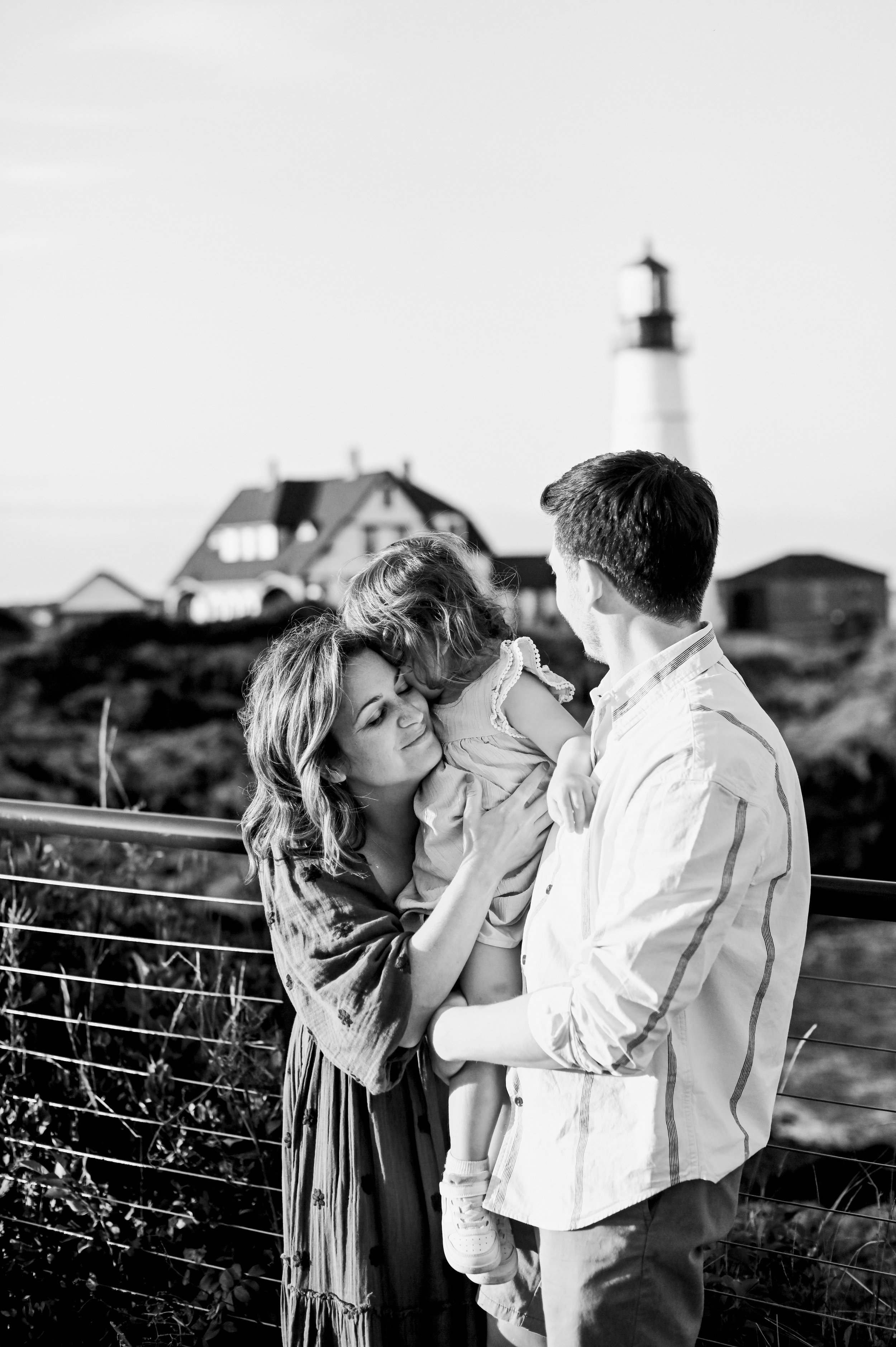 Cape Elizabeth lifestyle photoshoot with couple snuggling their toddler