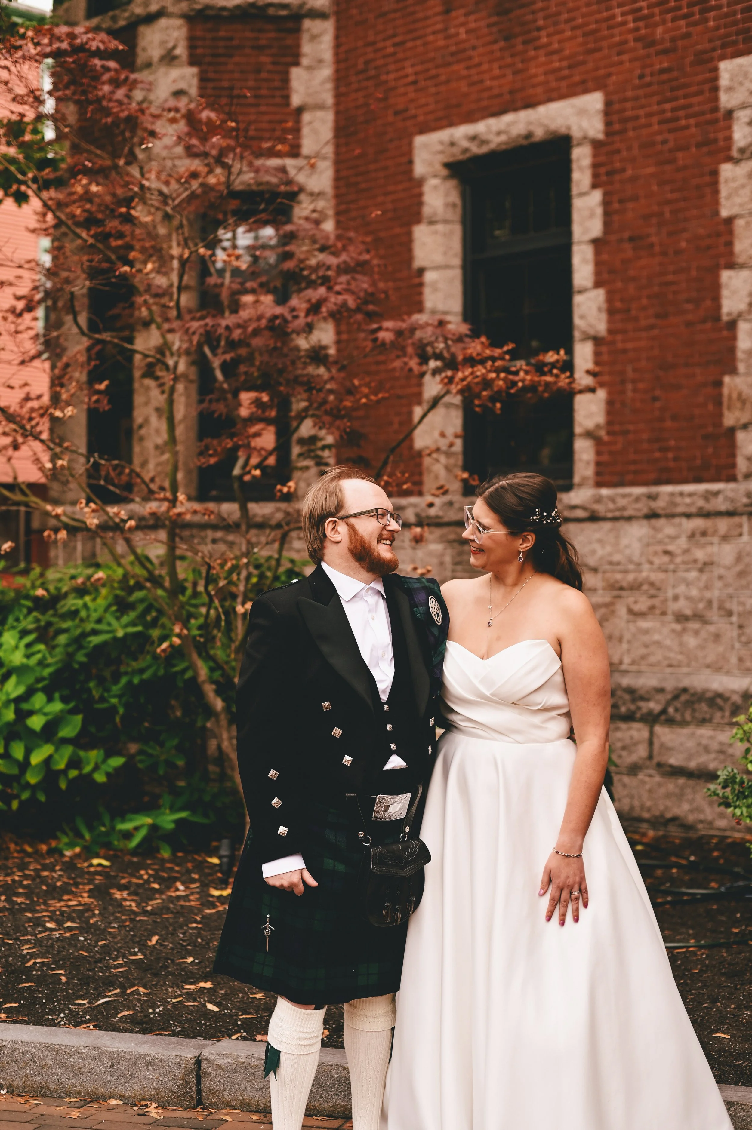 Person holding a modern, ceramic vase with a color gradient from dark to light and textured ridges.