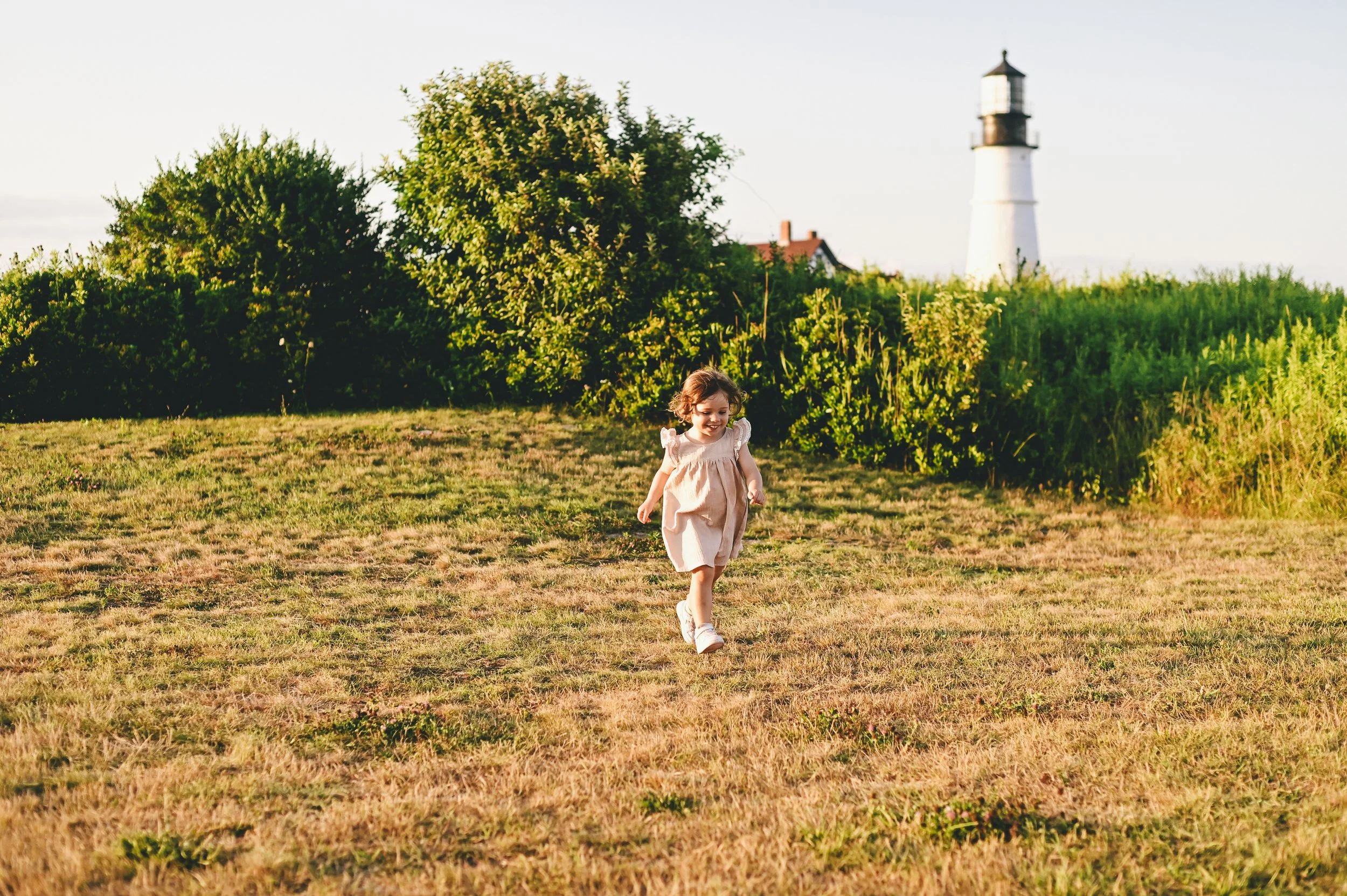 Toddler running during a candid family photoshoot in Cape Elizabeth