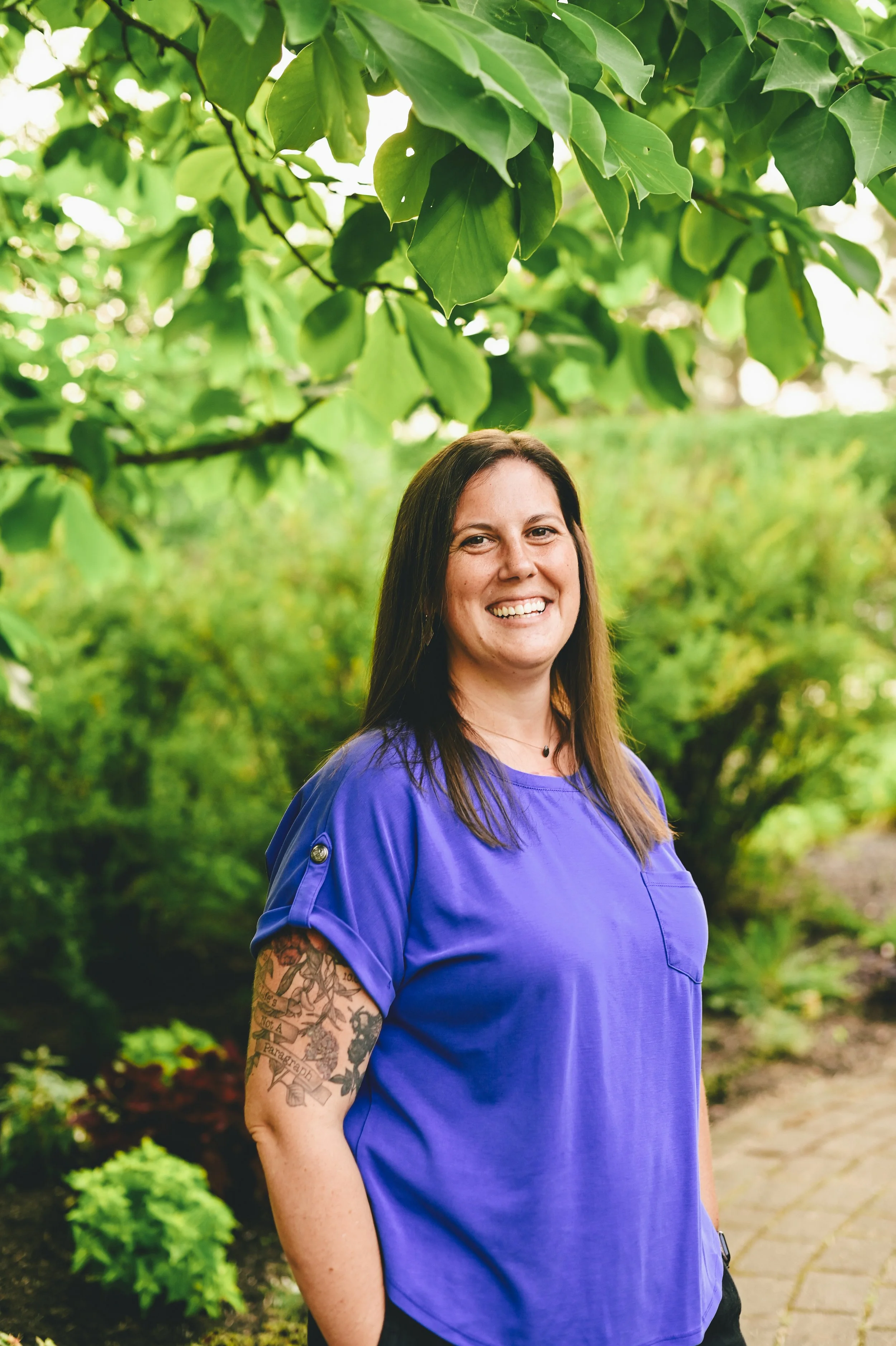 Two minimalist ceramic vases on a surface, one with dried flowers and seed pods, against a plain taupe background.