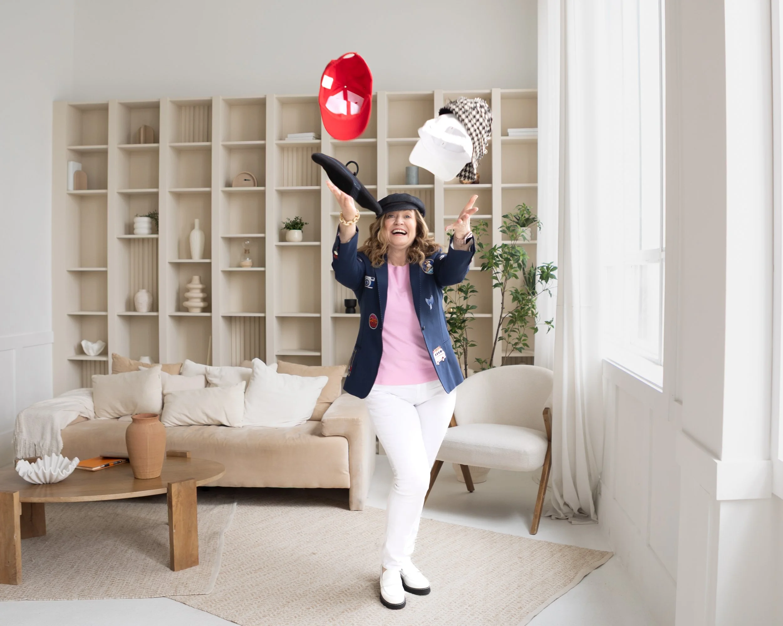 Hr Consultant Jo An Miele tossing multiple hats into the air, smiling