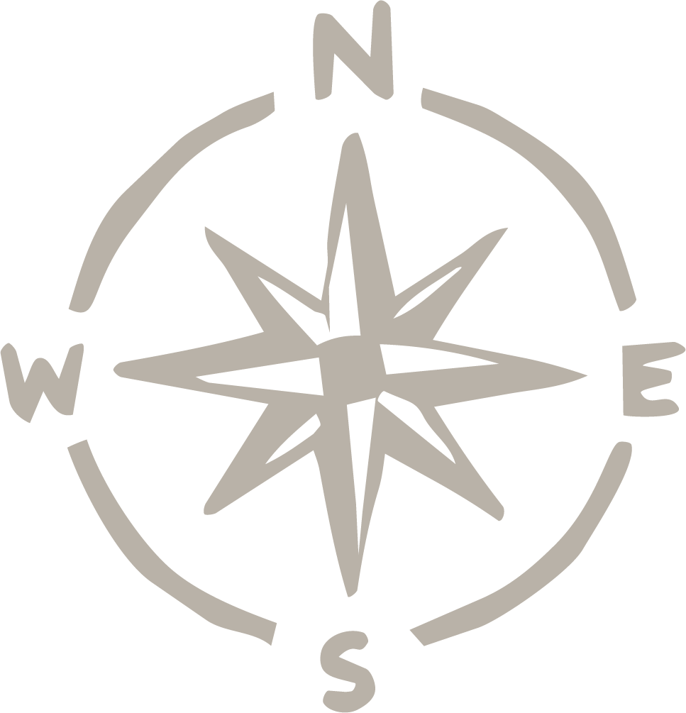 A monochrome compass rose indicating directions North, East, South, and West with a star-like design at the center.