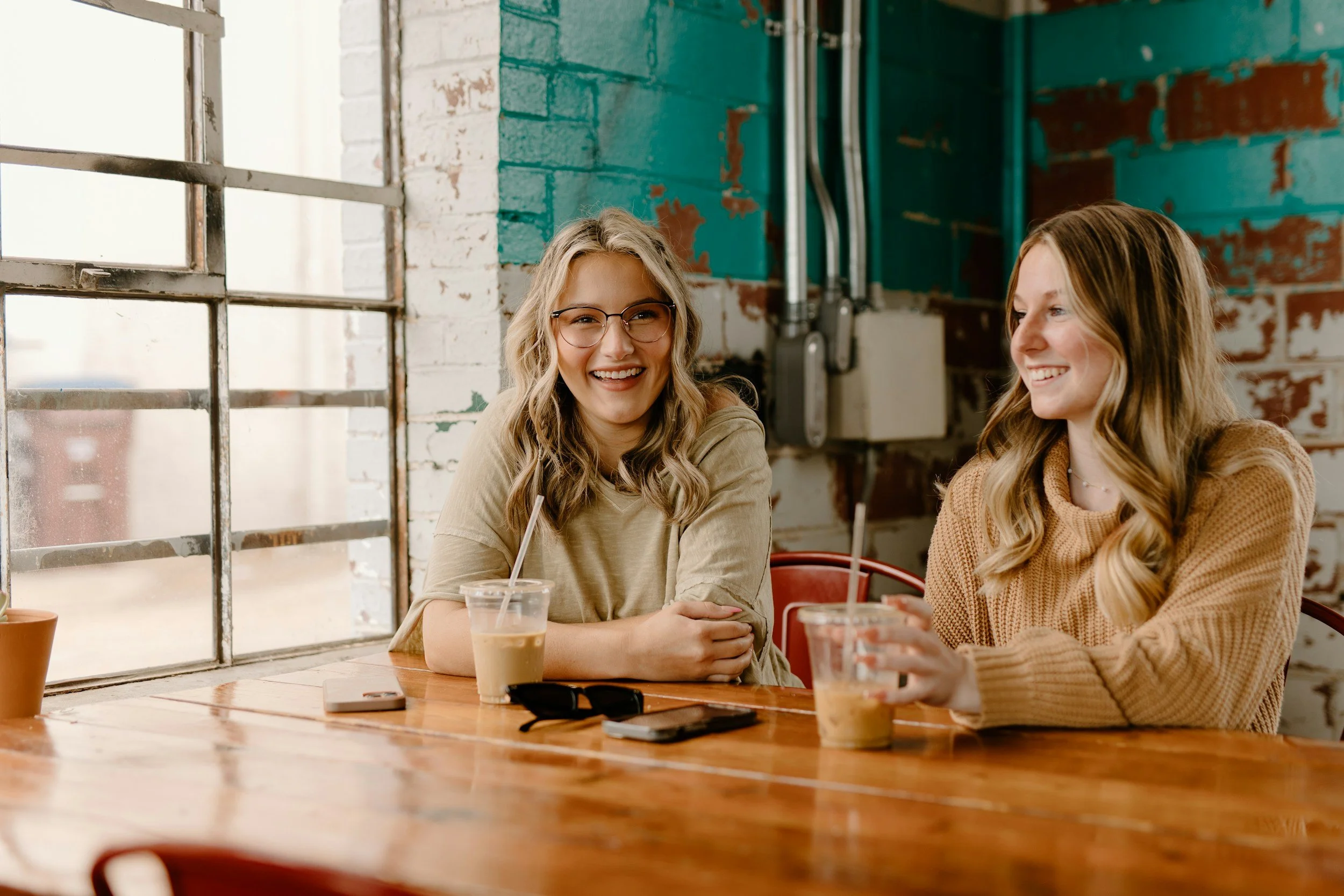 Two women getting coffee at a shop