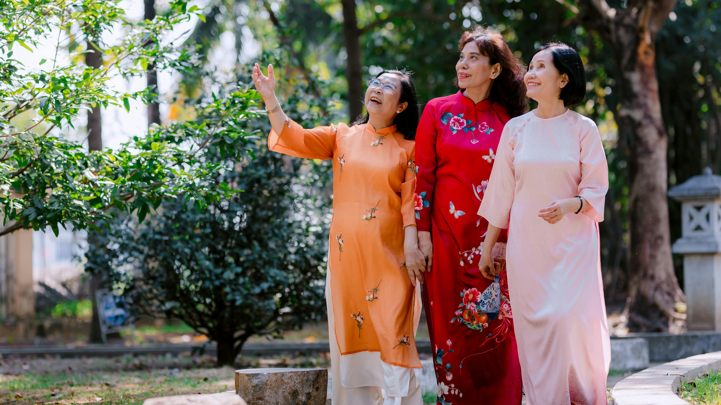 A group of elderly asian women wearing traditional Vietnamese clothing