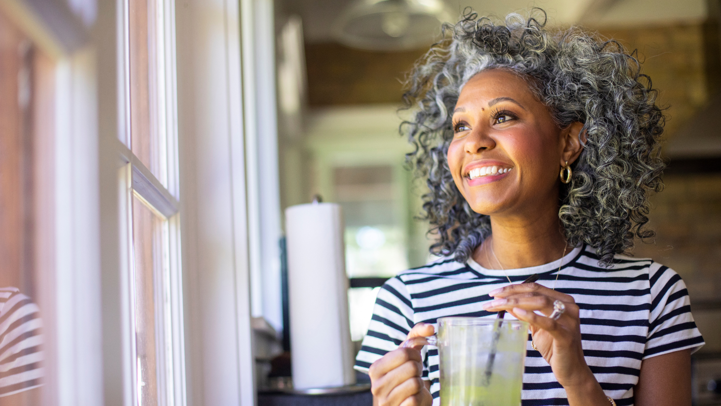 An older women drinking her matcha