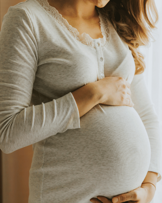 Pregnant women touching her belly