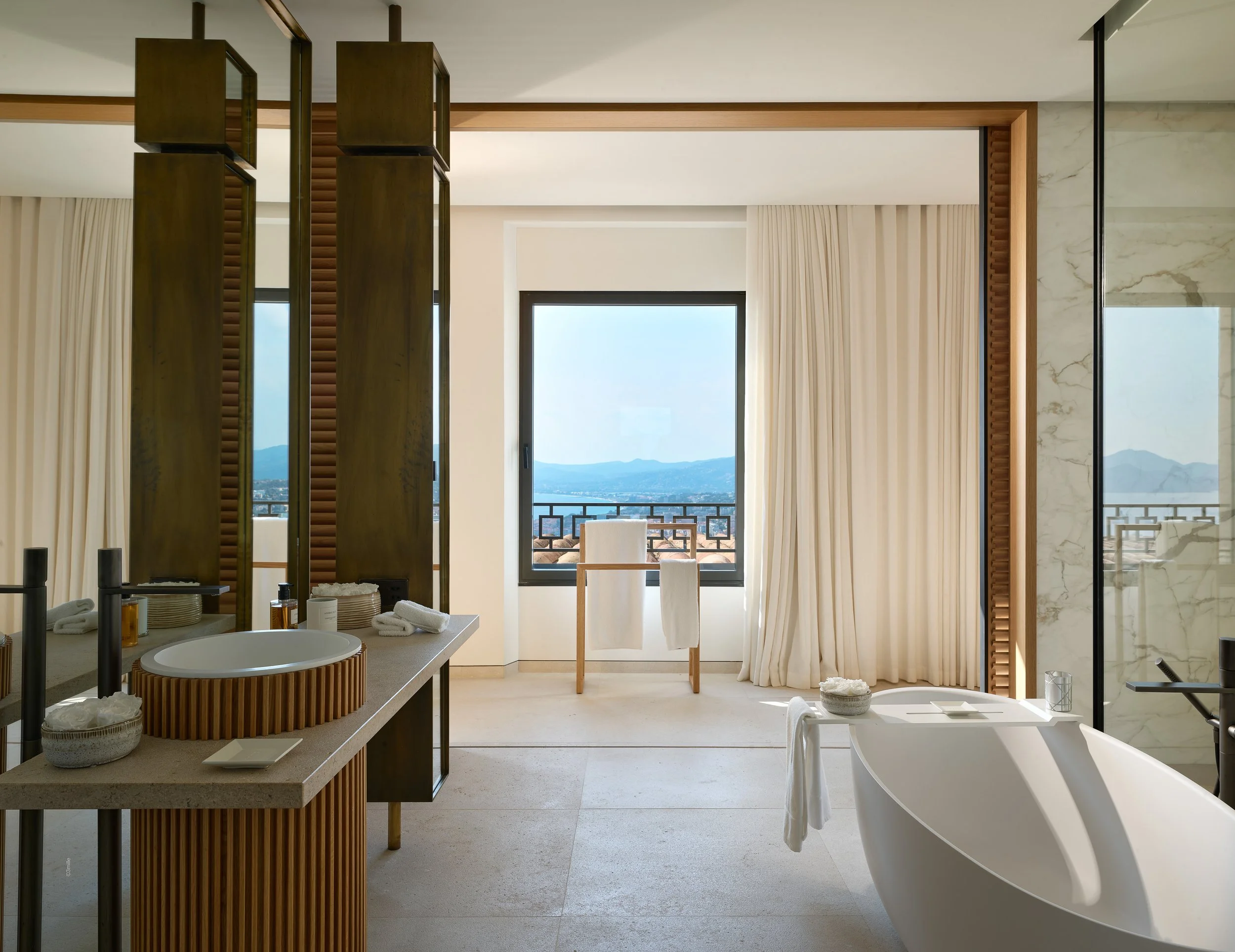 Salle de bain lumineuse avec vue sur la mer.