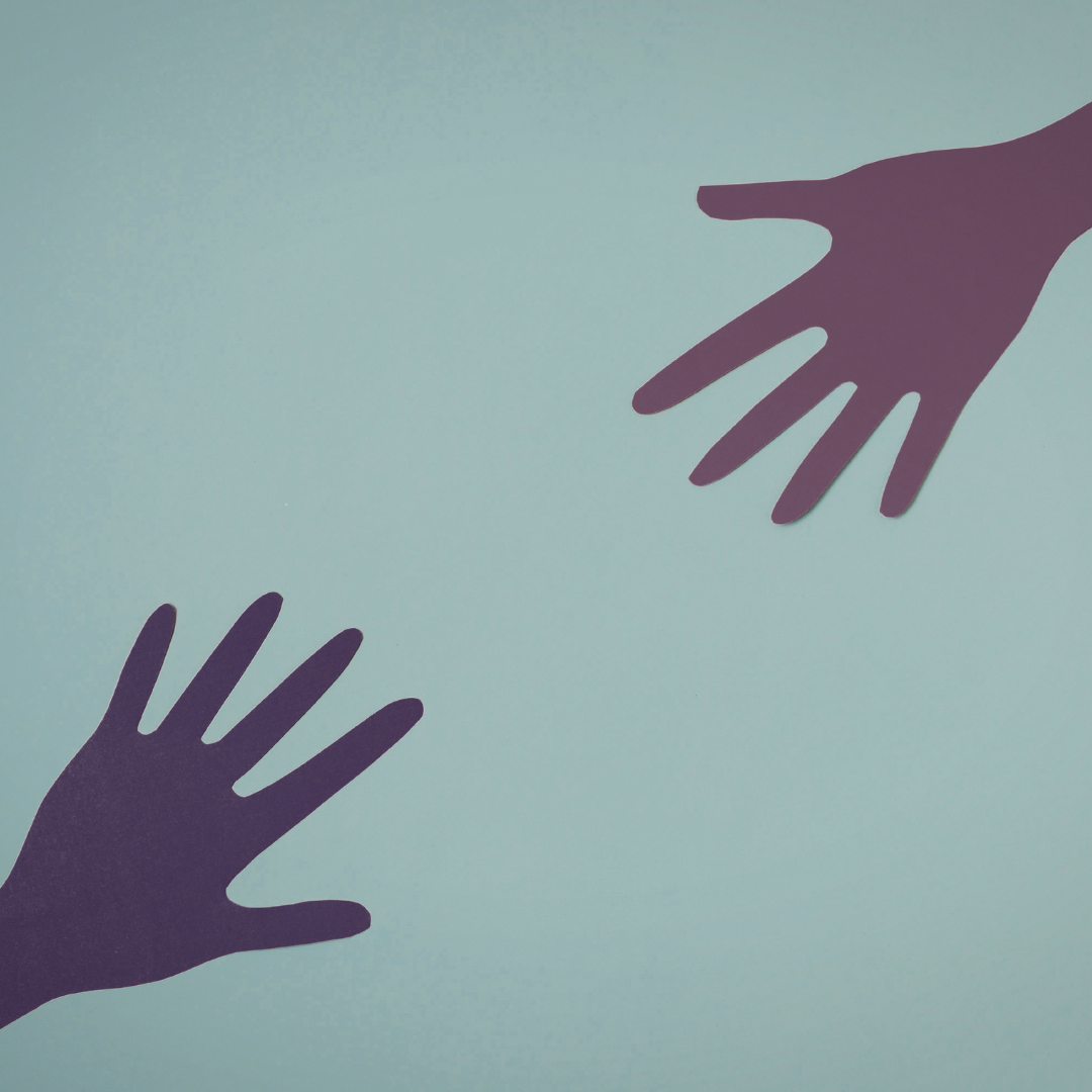 Silhouettes of two hands reaching towards each other on a light blue background.