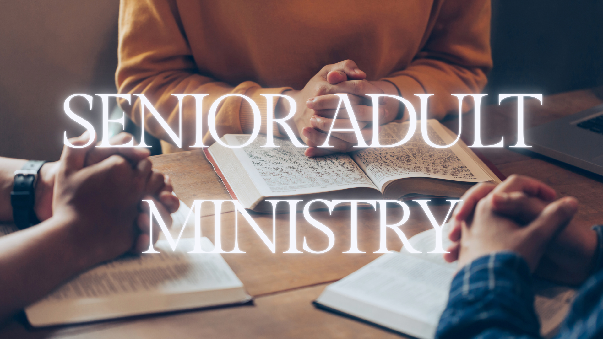 People praying at a table with open books and a laptop, with the words "Senior Adult Ministry" overlaid.