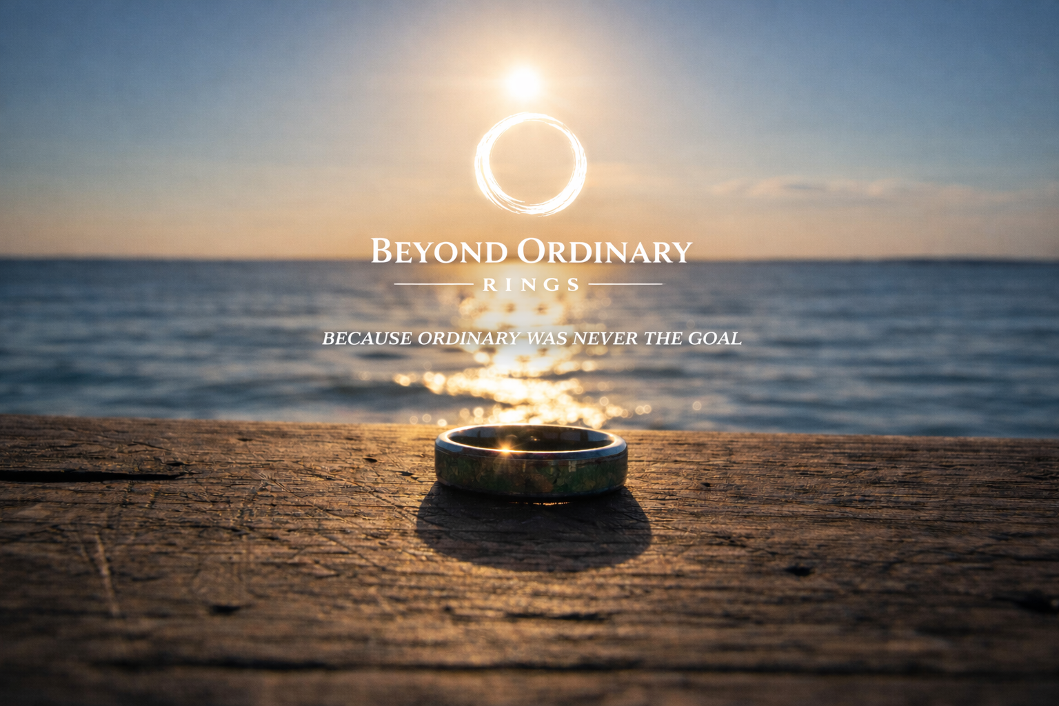 A wedding ring on a weathered wooden surface with an ocean and sunset in the background, overlaid with the text "Beyond Ordinary Rings" and the tagline "Because ordinary was never the goal."