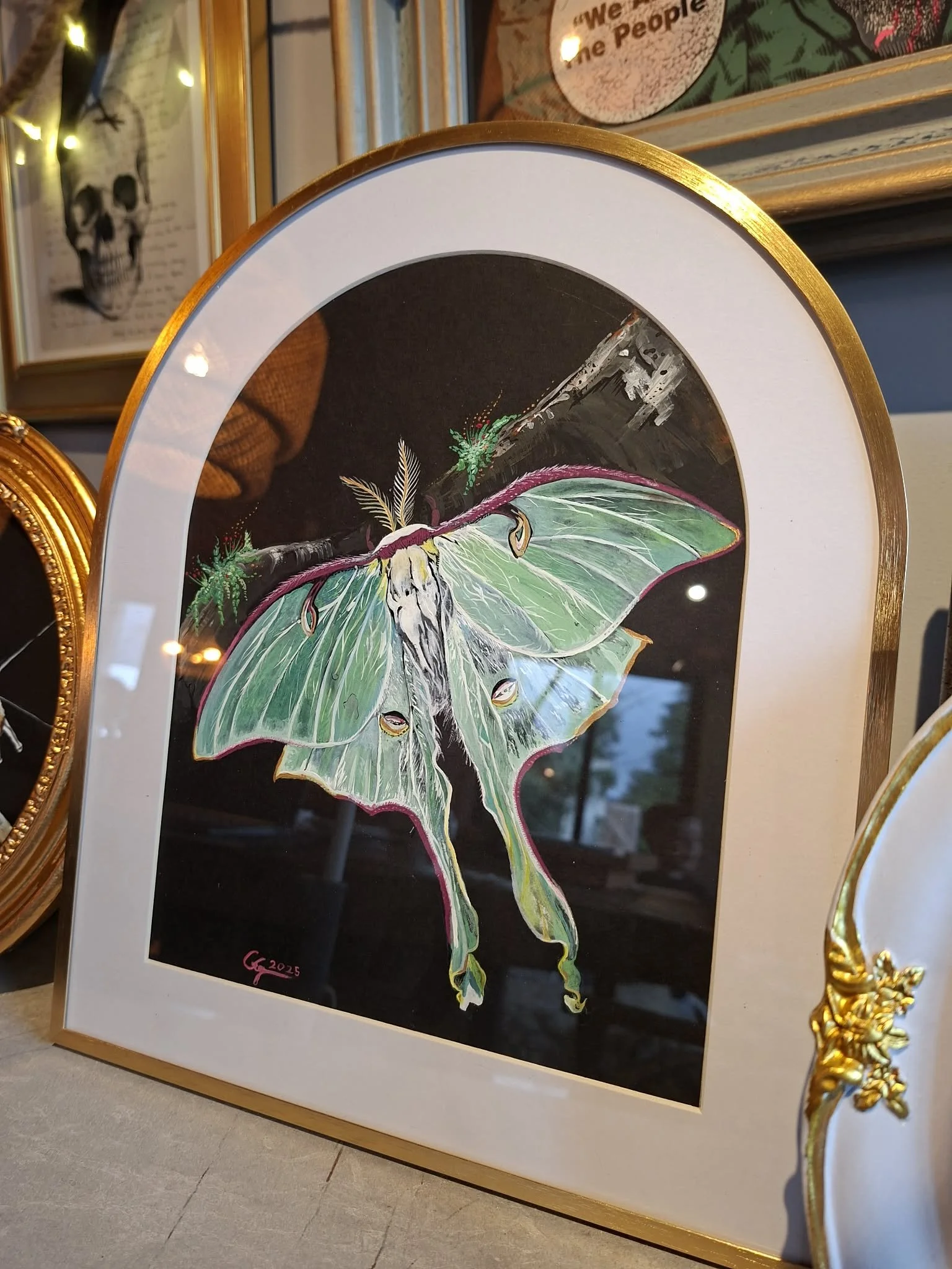 “Nocturne: Luna” 
Newly available €250
Gouache Original and comes with this arched frame. This is a highly detailed unique work.
12x 130x27cm. See Shop Page.

A luminous moth suspended in darkness, its pale green wings unfolding like silk against the