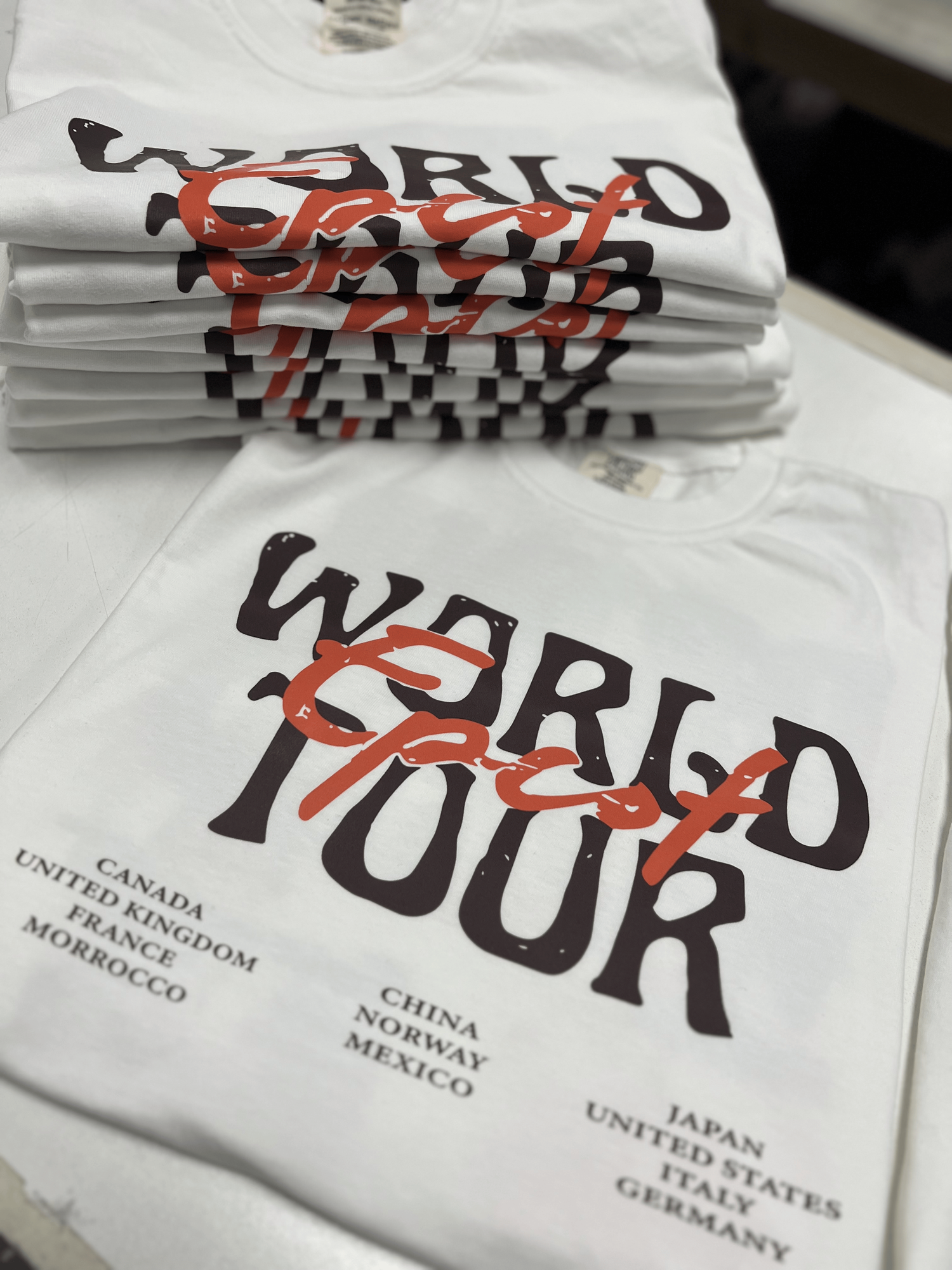 Folded custom World Tour birthday travel tees
