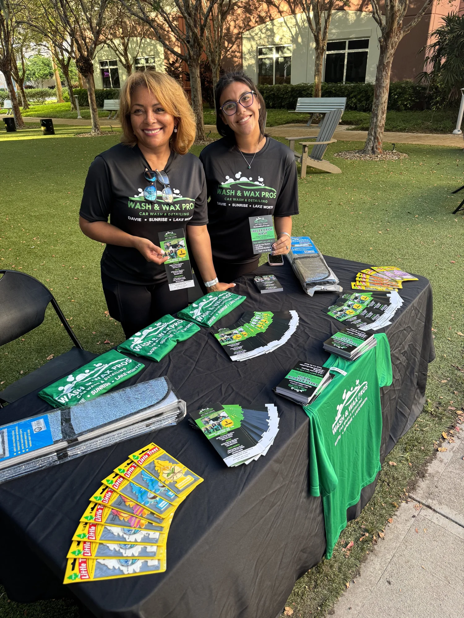 Event table with custom shirts, flyers and branded print items