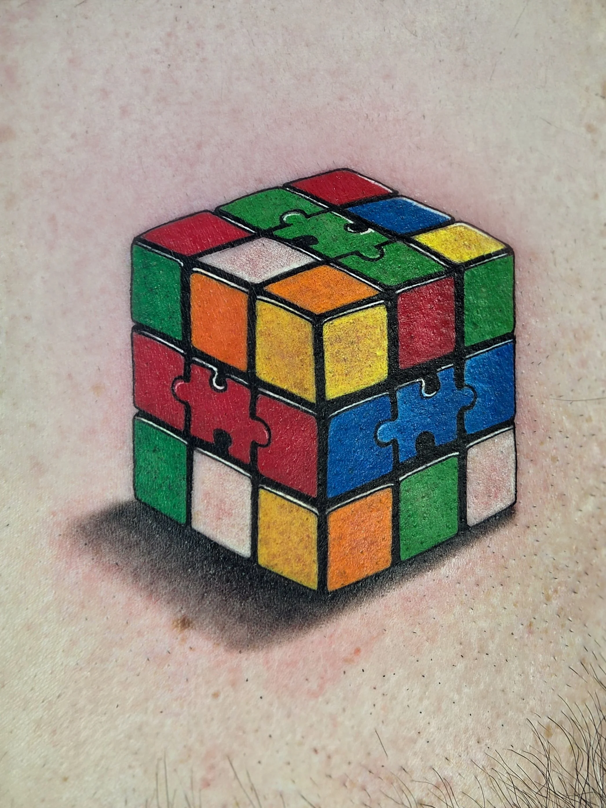 Tattoo of a Rubik's Cube on a person's skin.