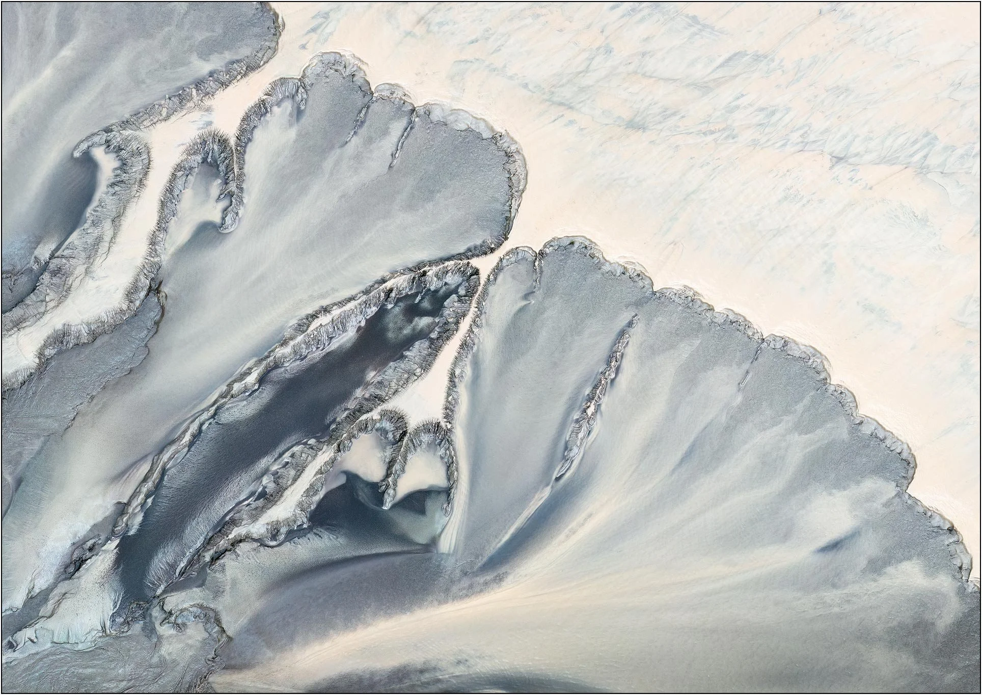 Minimalist aerial photography of the Qiantang River tidal flats in China, where tides sculpt soft layers of sand and sediment into elegant abstract forms. Subtle blue-gray contours rise like distant mountain peaks against pale negative space, reveali