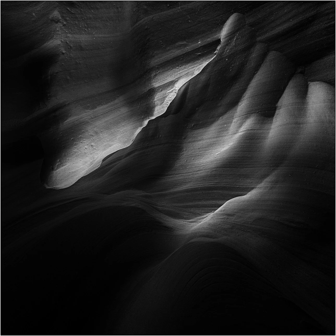 Abstract light and shadow patterns on smooth sandstone walls in Antelope Canyon