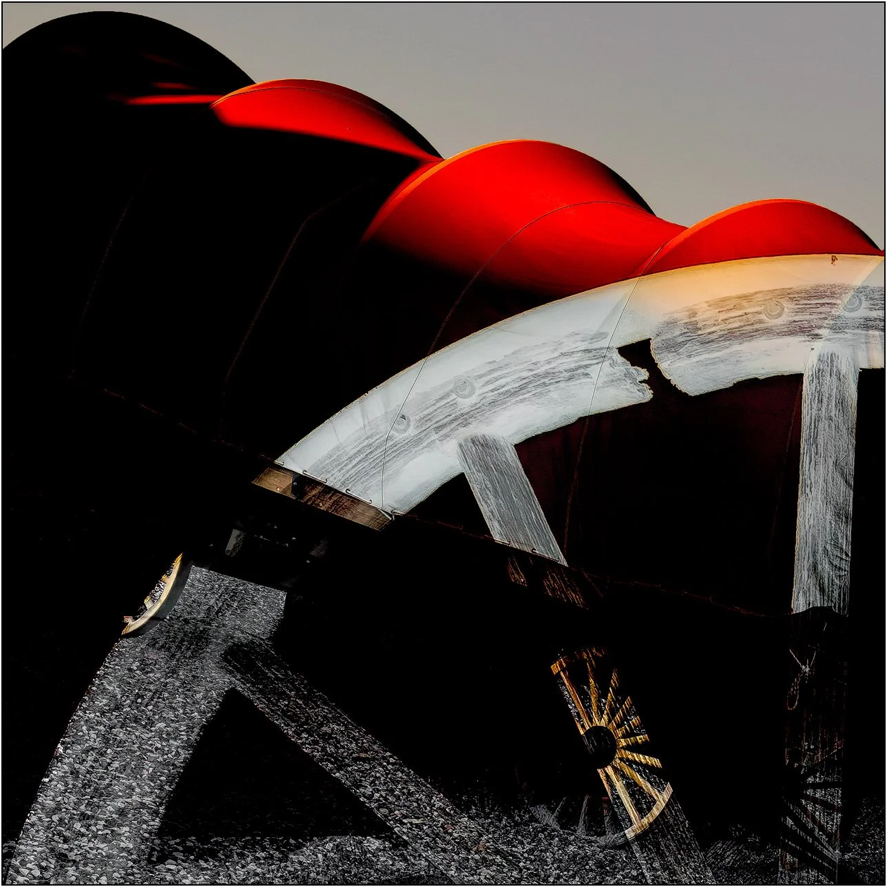 Abstract layered image of vintage wagon wheels and curved red forms in western style composition