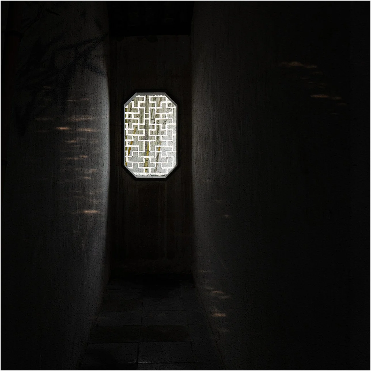 Traditional Chinese lattice window with light from outside.