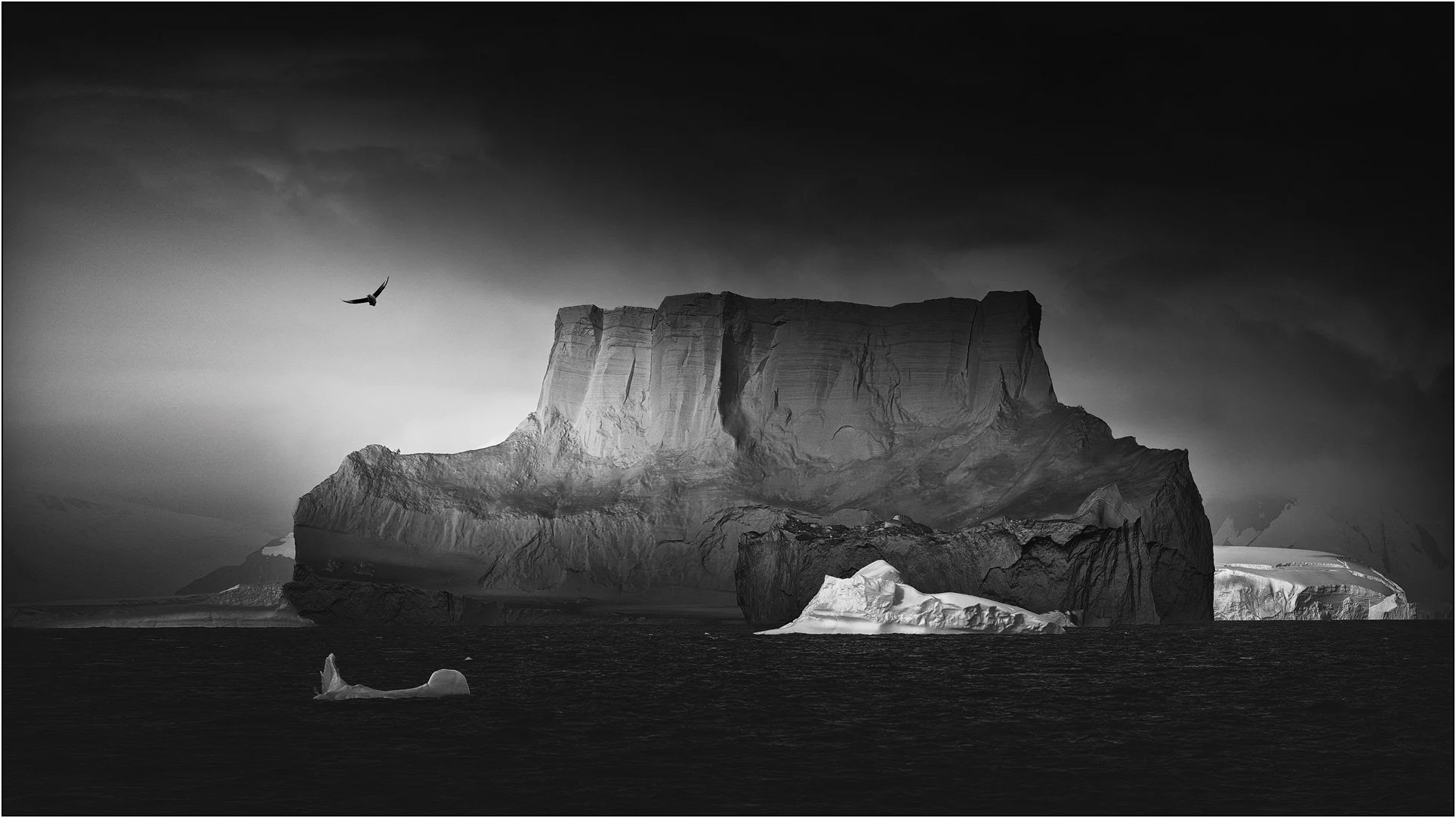Black and white photograph of icebergs floating on the southern ocean in Antarctica.