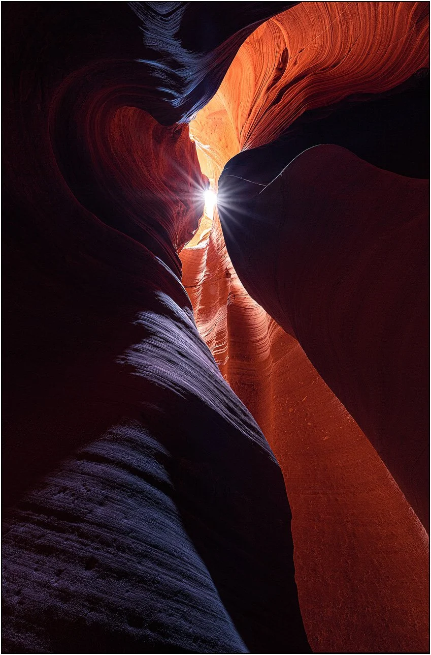 Sunlight streaming through narrow Antelope Canyon slot canyon walls in Arizona