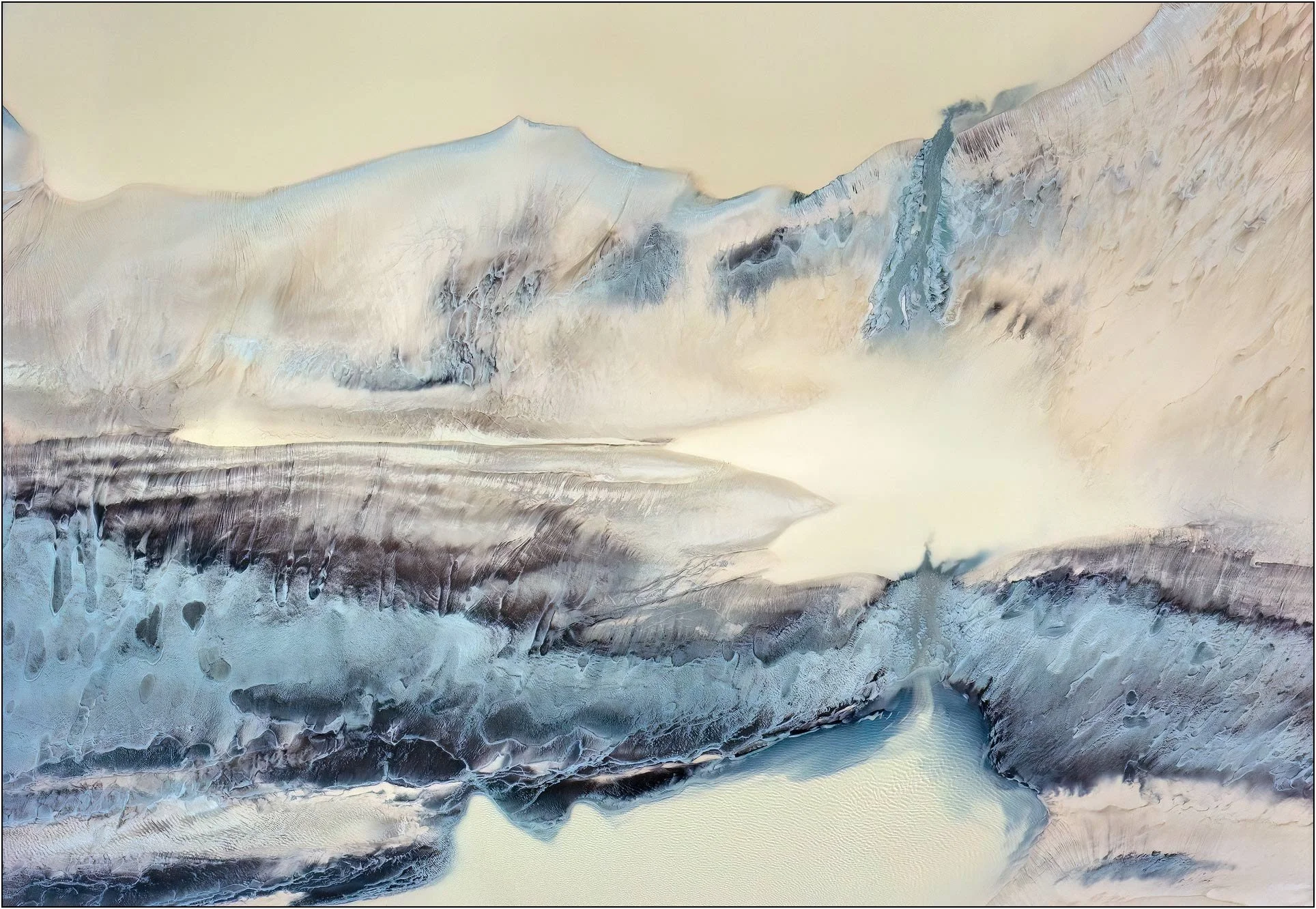 Fine art aerial photography of the Qiantang River tidal flats in China, where pale sand, blue-gray sediment, and tidal channels create a dreamlike abstract landscape. Sculpted entirely by water, the layered forms evoke misty mountains and flowing riv