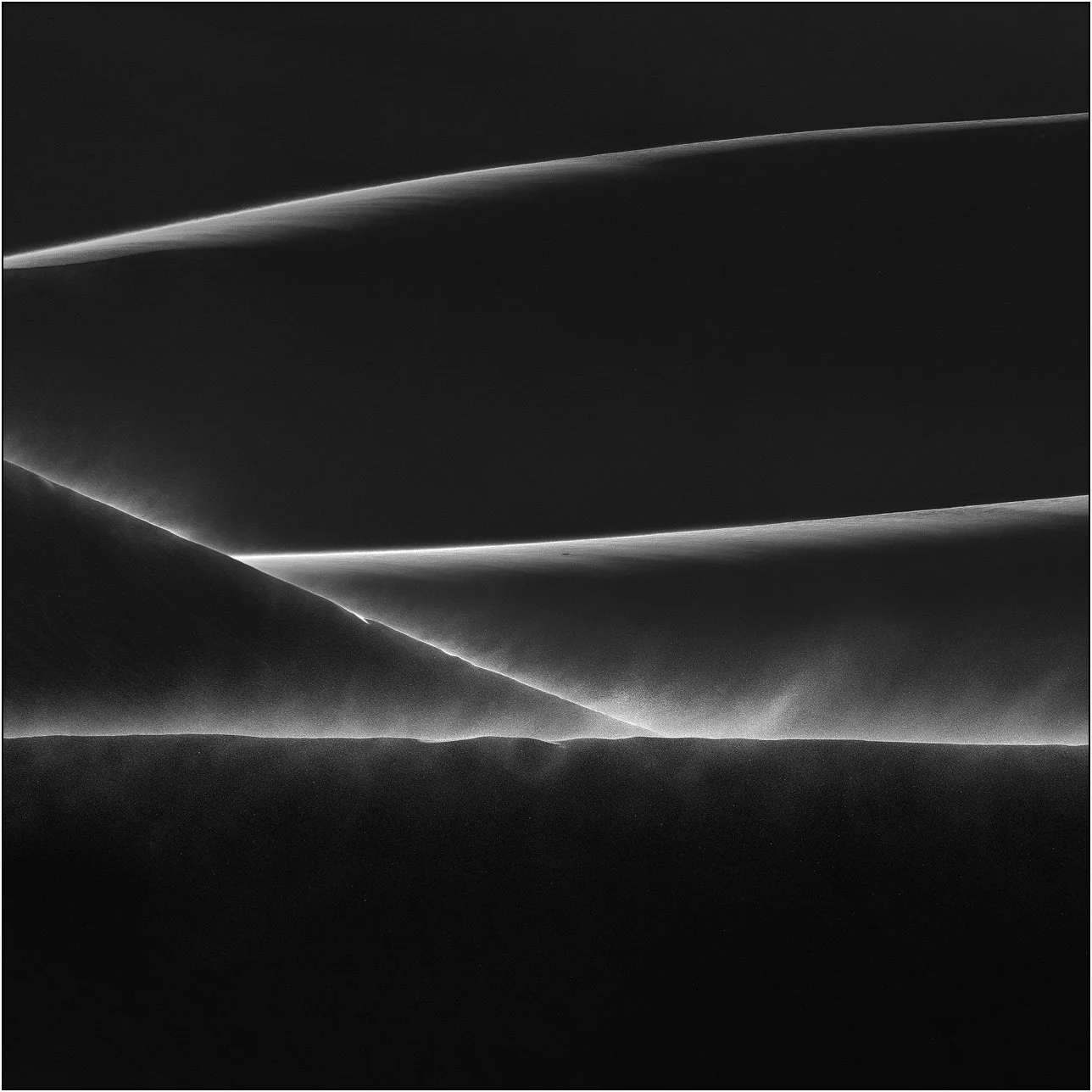 Abstract sand dunes with intersecting lines and wind-blown textures in monochrome