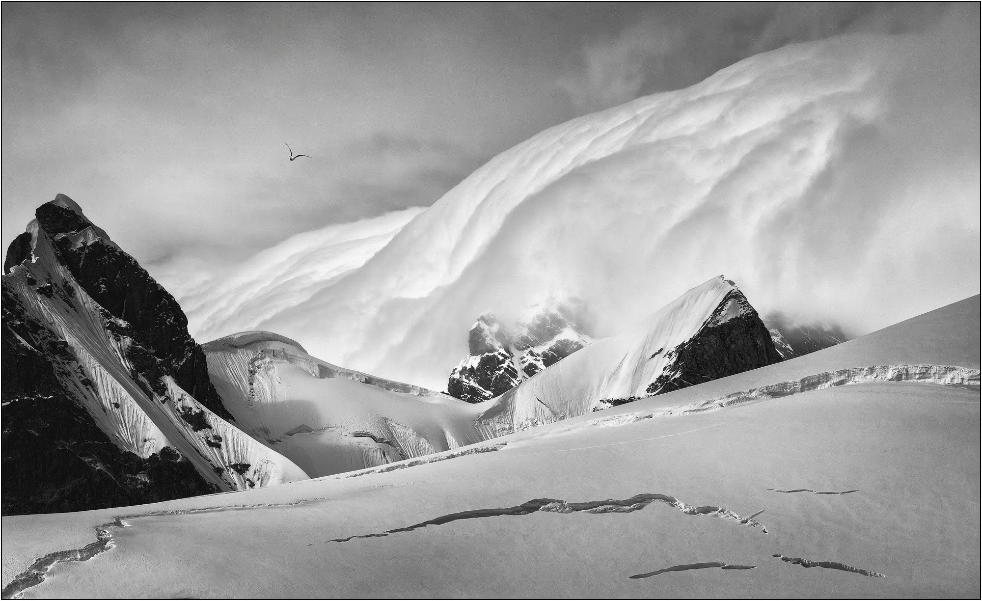 Massive rolling clouds swipe over mountains in Antarctica.
