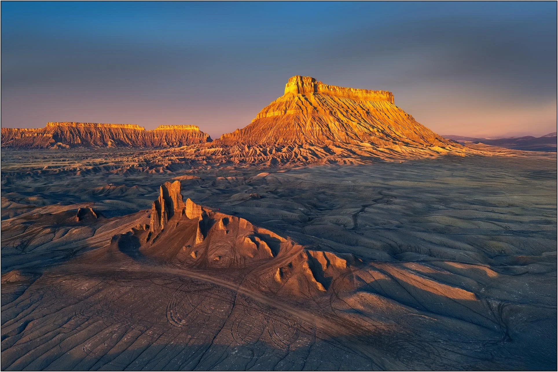 Factory Butte landscape under golden sunrise light