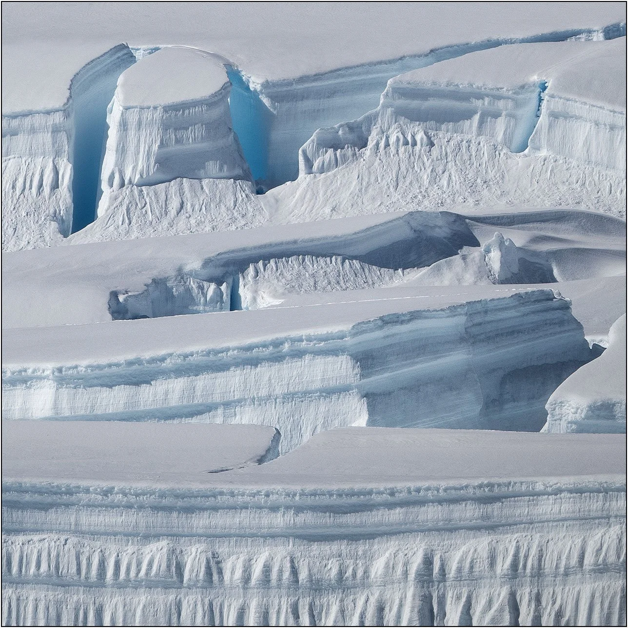 Snow cliffs and ice crevasses in Antarctica.