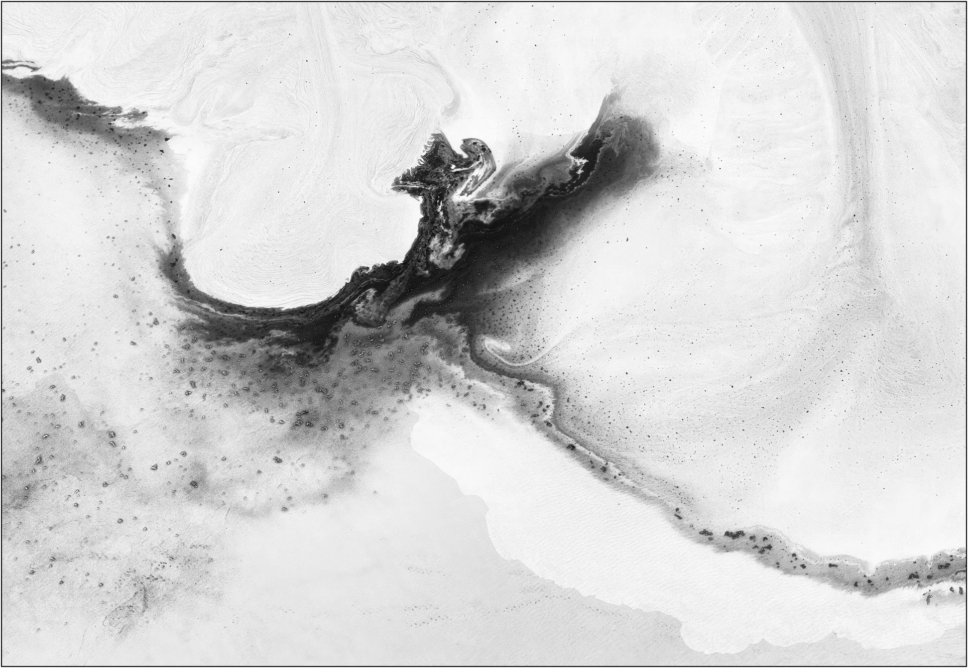 Aerial abstraction of a tailings lake with a central dark form spreading like ink across a pale surface