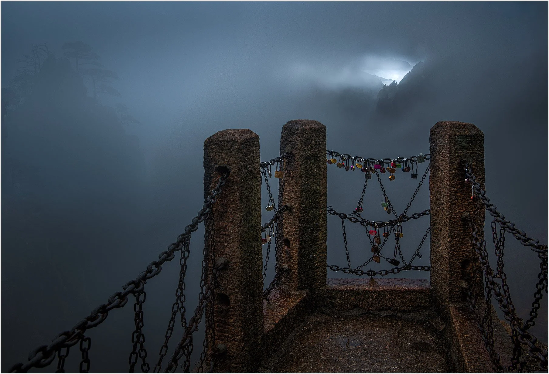 Wishing locks and mountains in thick fog in Huangshan, China.