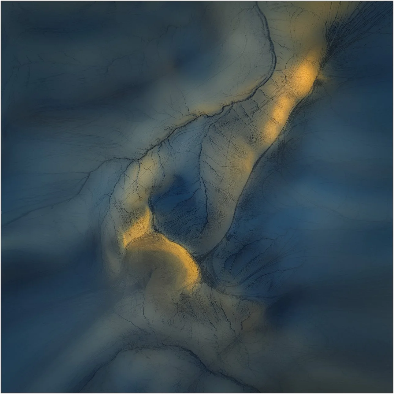 Abstract patterns of light and shadow flowing across textured surfaces of badlands  in blue and gold tones