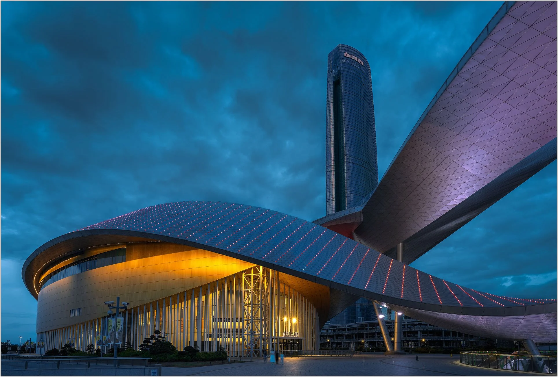 Suzhou Bay culture center in China at night, with futuristic curved architecture and lighting.