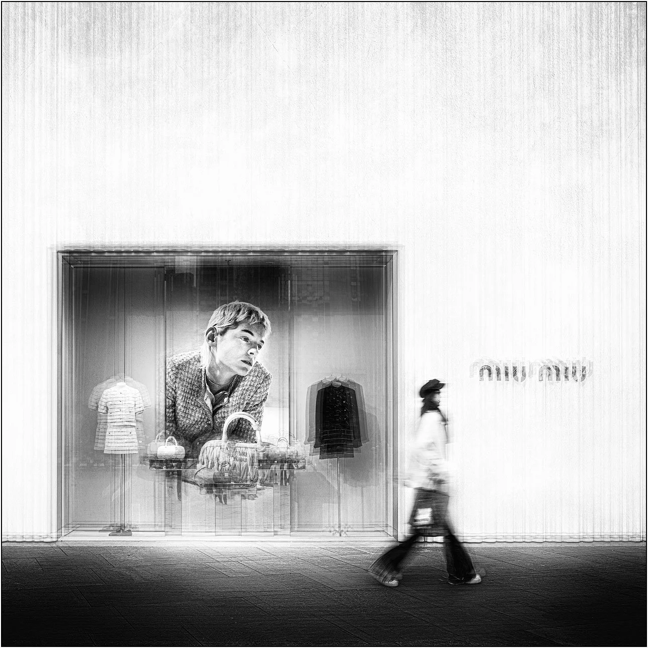 Fashion storefront window display with motion blur of a person walking by.