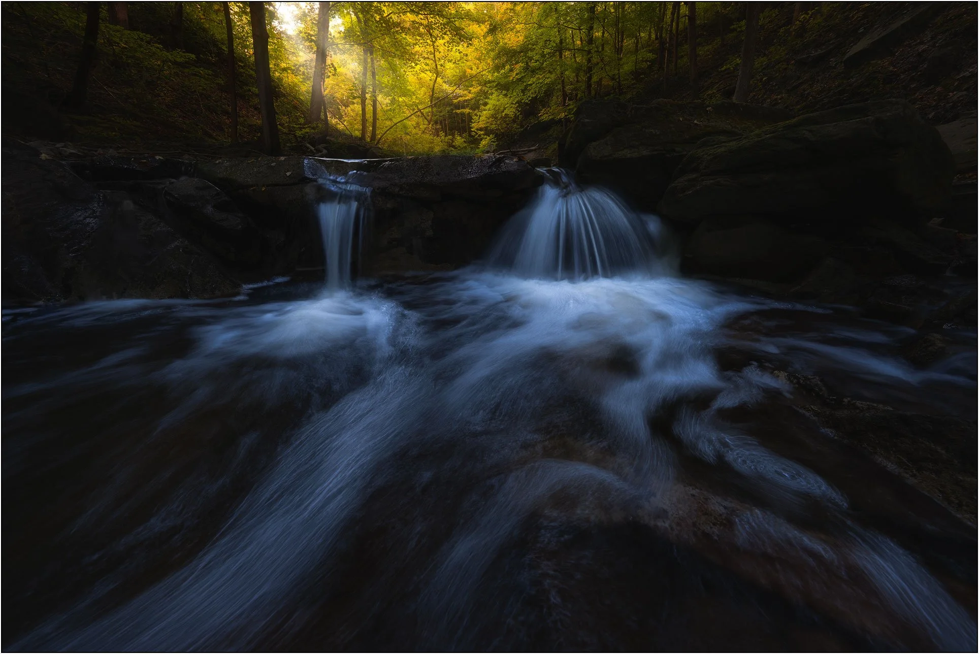 Small waterfalls and fall forest in Canada.