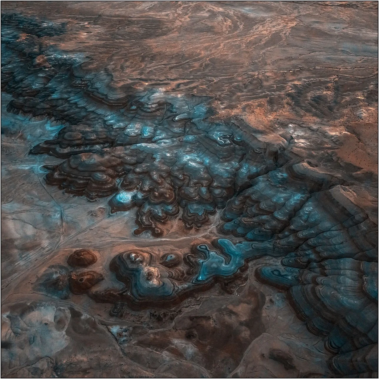 Aerial abstract of bentonite formations with blue mineral patterns