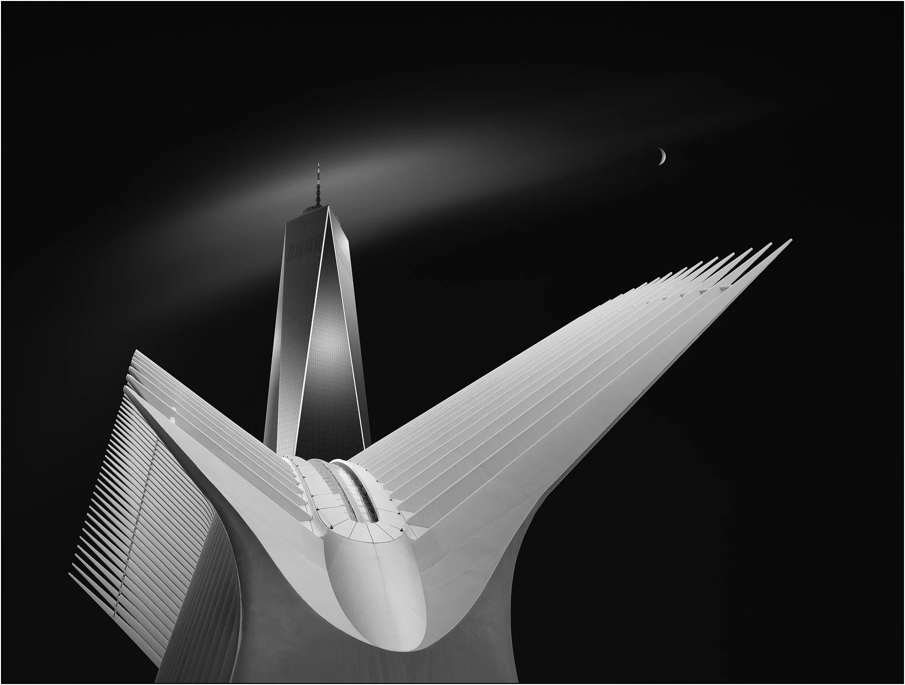 White wing-like structure of the World Trade Center Transportation Hub beneath One World Trade Center and a crescent moon in a dark sky