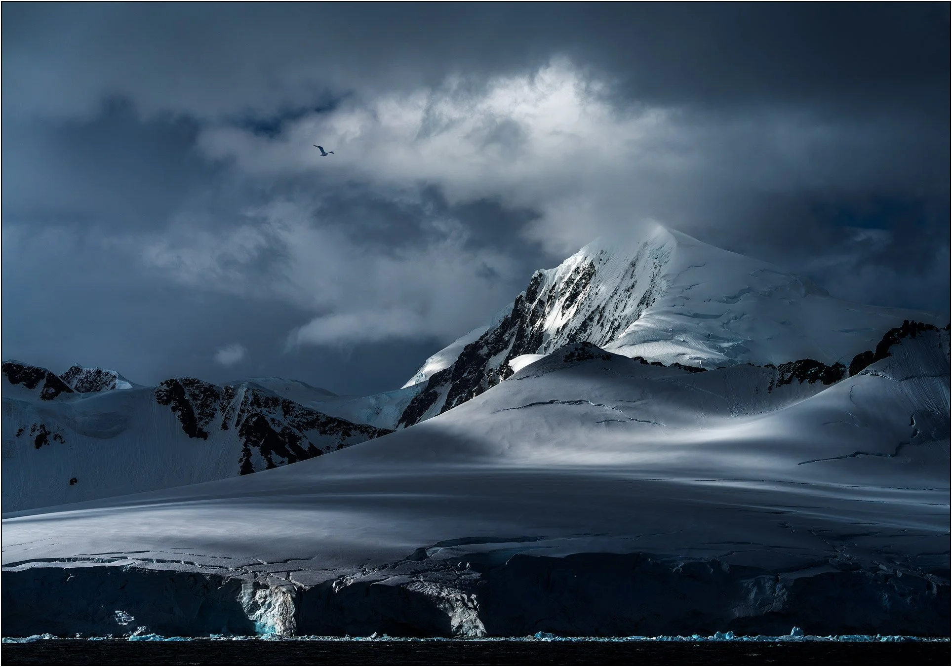 Dramatic light on mountains in Antarctica peninsula.