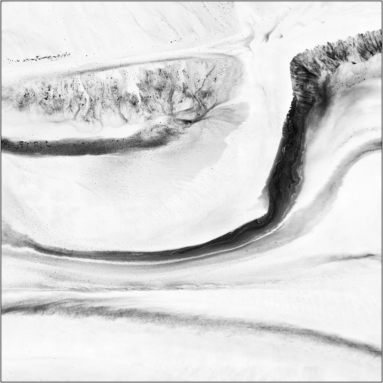 Abstract aerial composition with fluid ink-like motion and a sense of emerging form