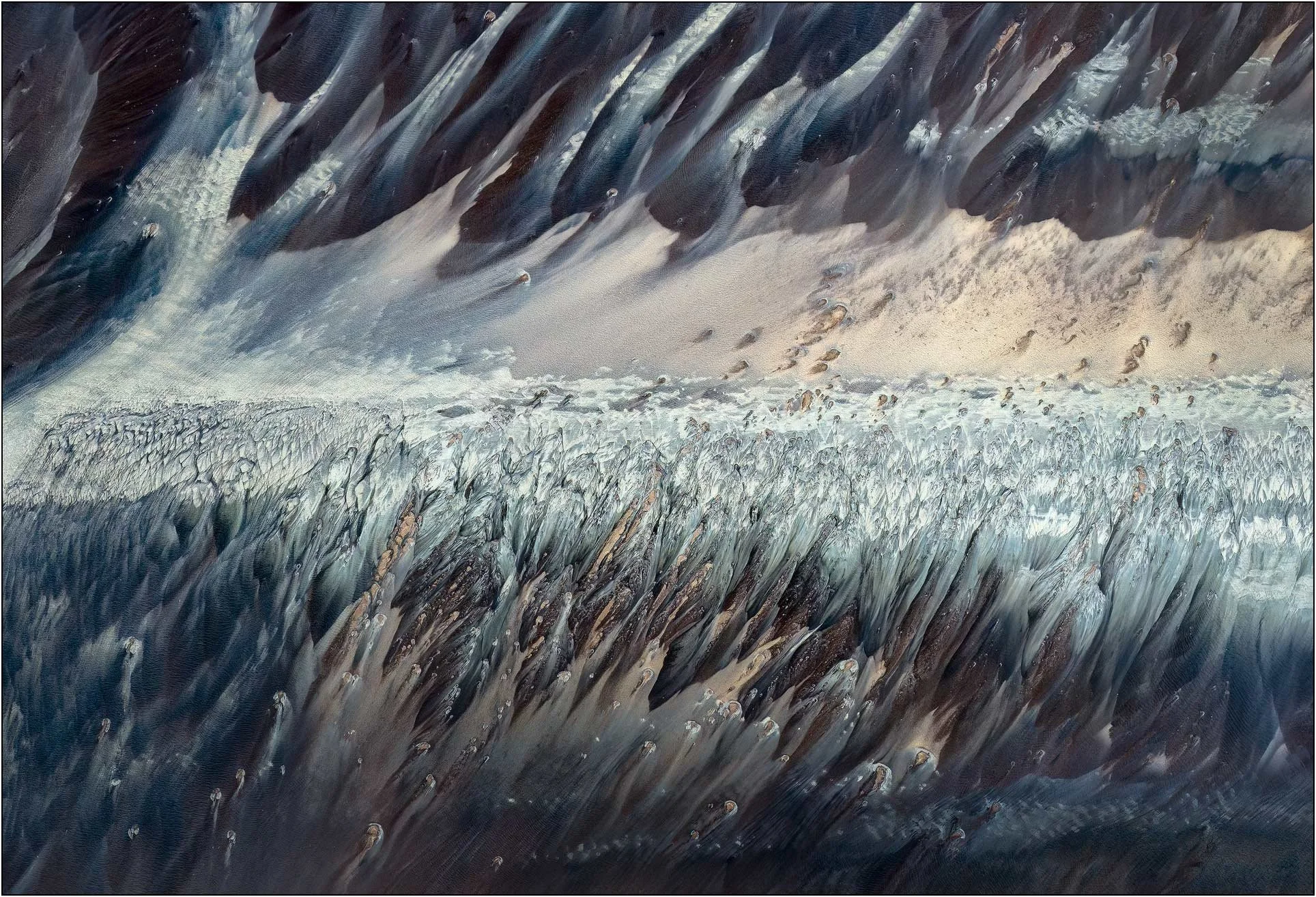 Fine art aerial photography of the Qiantang River tidal flats in China, where tidal currents sculpt sand and sediment into sweeping, rhythmic patterns. Dark flowing forms and pale ridges create a dynamic abstract landscape, capturing the energy and m